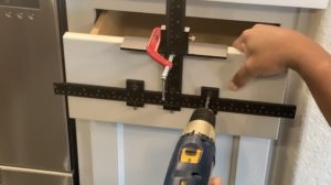 Drill through drawer to install cabinet pulls